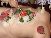 Nude japanese fat woman with sushi placed on her body